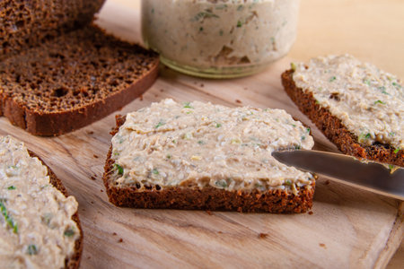 Slices of spread rye bread on wooden backgroundの写真素材