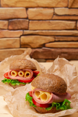 Turkey Sandwich With Tomato And Lettuce on brown brick wall background with copy spaceの写真素材