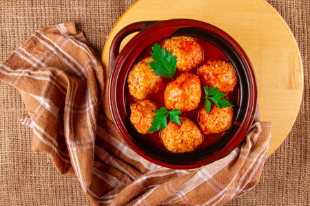 Clay pan with freshly-made kottbullar meatballs in red sauceの写真素材