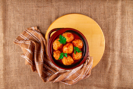 Chicken Meatballs in tomato sauce on sackcloth background with copy spaceの写真素材