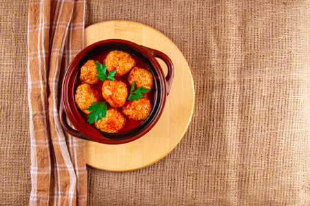 Tomato-simmered Sicilian-style meatballs on wooden hot pot standの写真素材