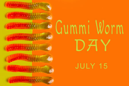 Gummi worms on colorful background with text: "Gummi worm day. July 15"の写真素材