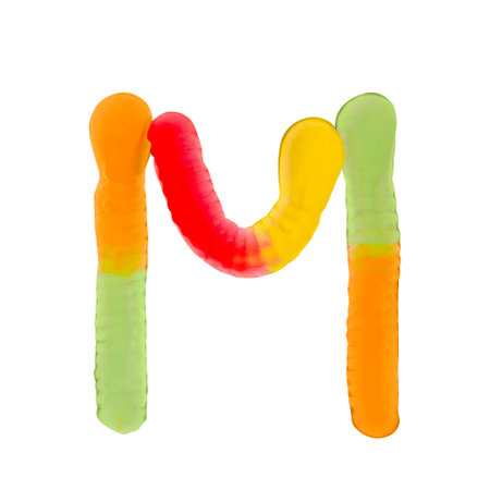 Letter M made of multicolored gummi worms and isolated on pure white background. Food alphabet concept. One letter of the set of sweet food font easy to stackingの写真素材