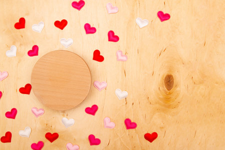 A lot of small hearts on wooden background with copy space. Enchanting love-filled greeting card.の写真素材