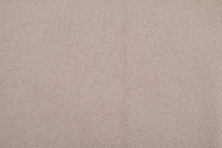 Texture of light beige knitted fabric background, top viewの写真素材