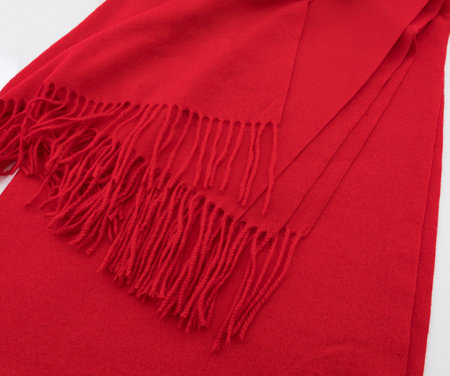 Red shawl texture fabric. Close-up of scarf with fringeの写真素材