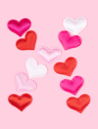 Letter X made of glossy atlas hearts isolated on solid pink background. Love alphabet concept. One letter of the set of heart's font easy to stacking.の写真素材