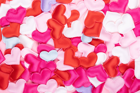 Valentine's background filled with small satin heartsの写真素材