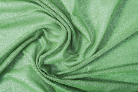 Texture of green draped fabric with metal threadsの写真素材