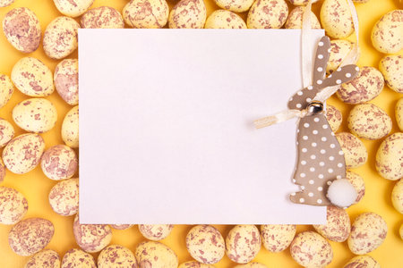 White blank postcard with easter bunny laying on easter eggs. Happy easter greeting card mockupの写真素材
