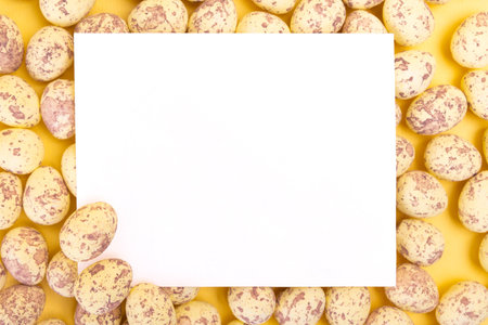 Blank white postcard among quail easter eggsの写真素材