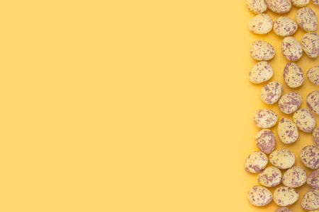 Quail Easter Egg right side border on bright yellow background with copy spaceの写真素材