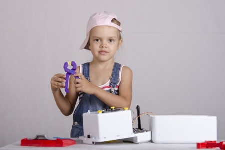 Girl repairs toy small home appliancesの写真素材
