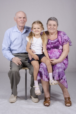 Group portrait  grandmother, grandfather and granddaughterの写真素材