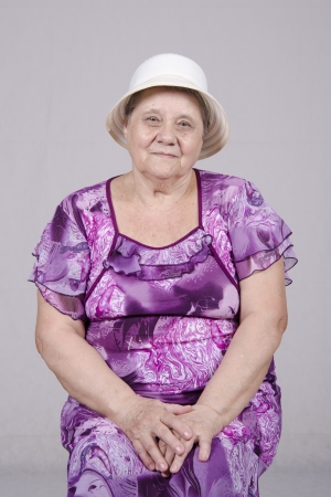 Portrait of an elderly woman in a hatの写真素材