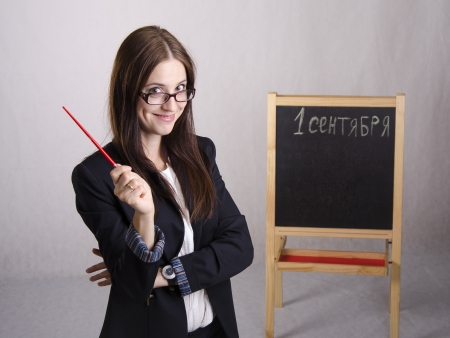Portrait of the teacher, with a pointer and a Board in the backgroundの写真素材