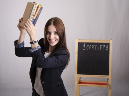 Master cheerfully raised over the head of textbooks  Portraitの写真素材