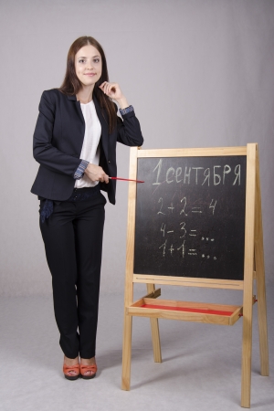 Portrait of the teacher with a pointer at the Boardの写真素材