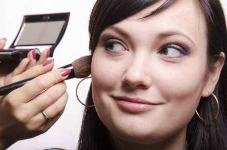 Makeup artist deals powder on the face modelの写真素材