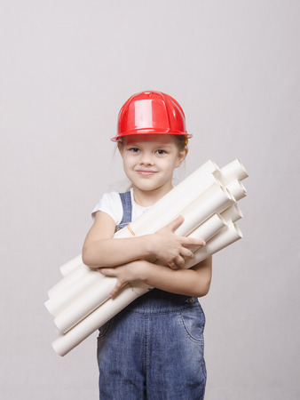 Girl Builder keeps a bunch of drawings and smilesの写真素材