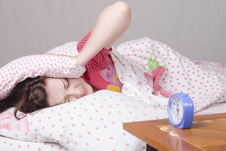Girl sleeping in bed. It wakes serviceの写真素材