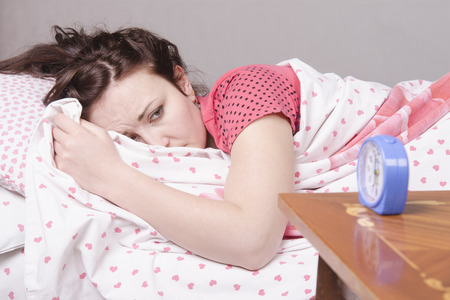 Girl sleeping in bed. It wakes serviceの写真素材