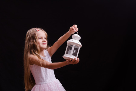 Five year old girl standing with a candlestickの写真素材