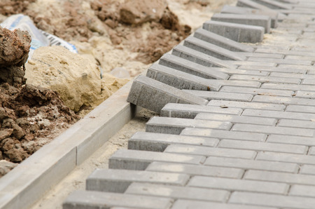 Laying of paving slabs to the curbの写真素材