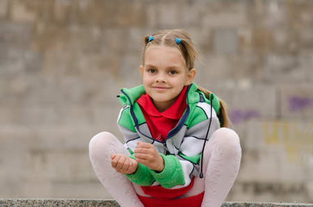 A girl of six years walking on the embankmentの写真素材