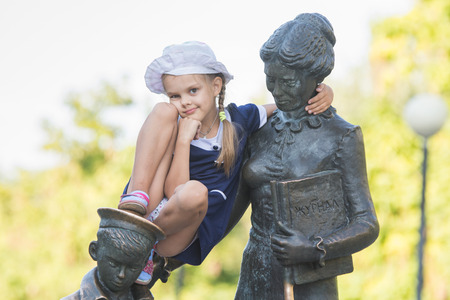 Girl climbs first teacher sculpture located in the Krasnoarmeysk district of Volgograd Boulevard Engelsの写真素材