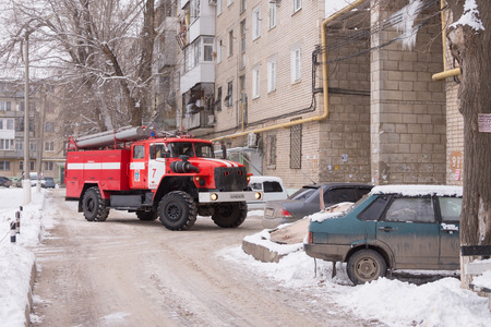 Volgograd, Russia - January 24, 2016: Machine prevents fire service leave many cars parked at the...