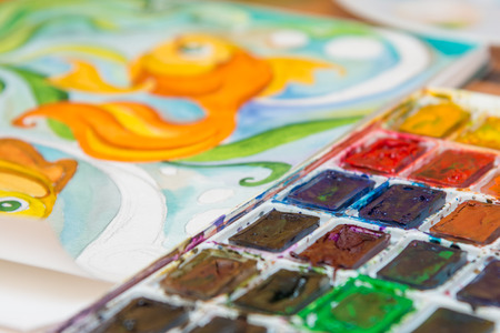 Close-up of watercolors and a fragment of the picture goldfishの写真素材