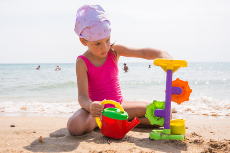 A child plays with toys in the sand on the beachの写真素材