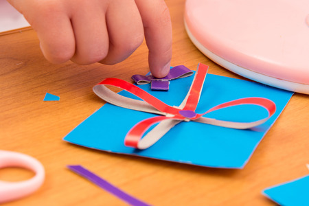 The child sticks to the bow Crafts for mom, close up