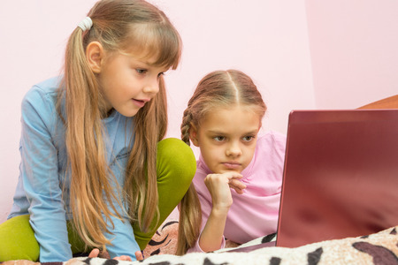 Sisters looking at a laptop cartoon