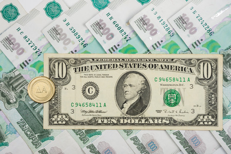 On the Russian ruble is 10 American dollars and coins with the inscription "yes"の写真素材