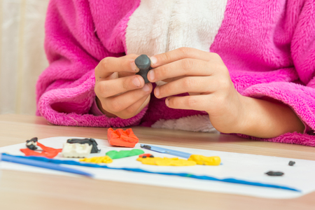 A child holding a blank crafts from plasticineの写真素材