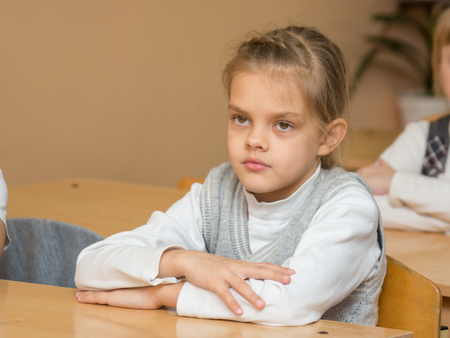 Diligent student in the classroom listening to a teacher at school