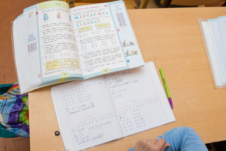 Anapa, Russia - February 28, 2017: Top view of the party for which the student is sitting on the desk lay a textbook and notebookのeditorial素材