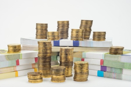 Bundles of bills around are stacks of coinsの写真素材