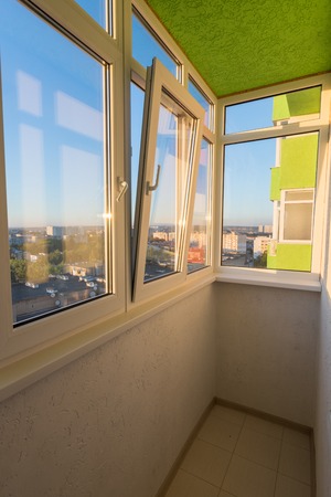 A small glazed balcony in the apartment of a multi-storey residential building
