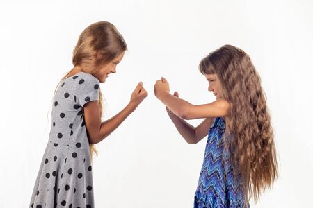 Two girls are fighting, studio white backgroundの写真素材