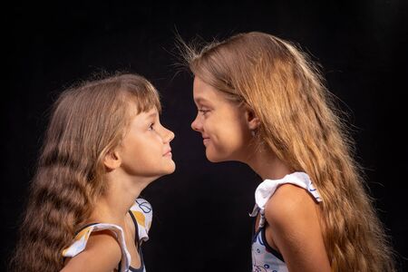 Two girls look at each other face to faceの写真素材