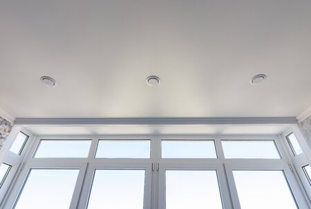 View of the stretch edafter ceiling and part of the glazed-to-ceiling windows
