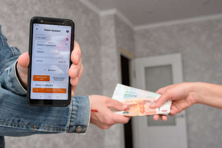 Anapa, Russia - March 11, 2020: Self-employed person receives money for the repair of the premises...