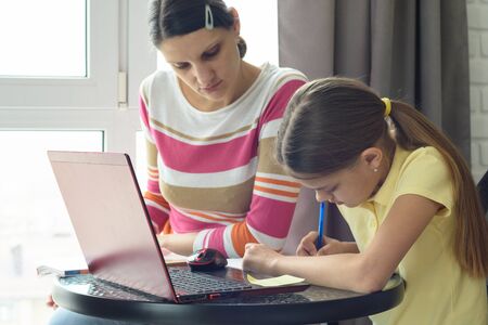 Mom helps daughter do homework