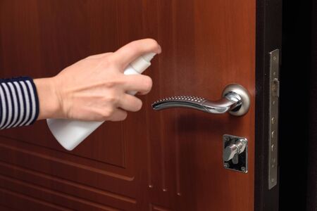 Hand protects the handle on the entrance doorの写真素材