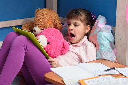Girl watching a boring video lesson while studying remotely at home