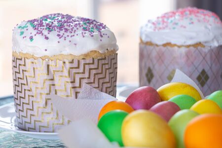Two Easter cakes and colorful eggs closeup