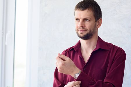 young man in the morning dresses shirt while going to office work